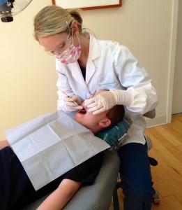 Dr. Budolfson performing a  professional dental cleaning.